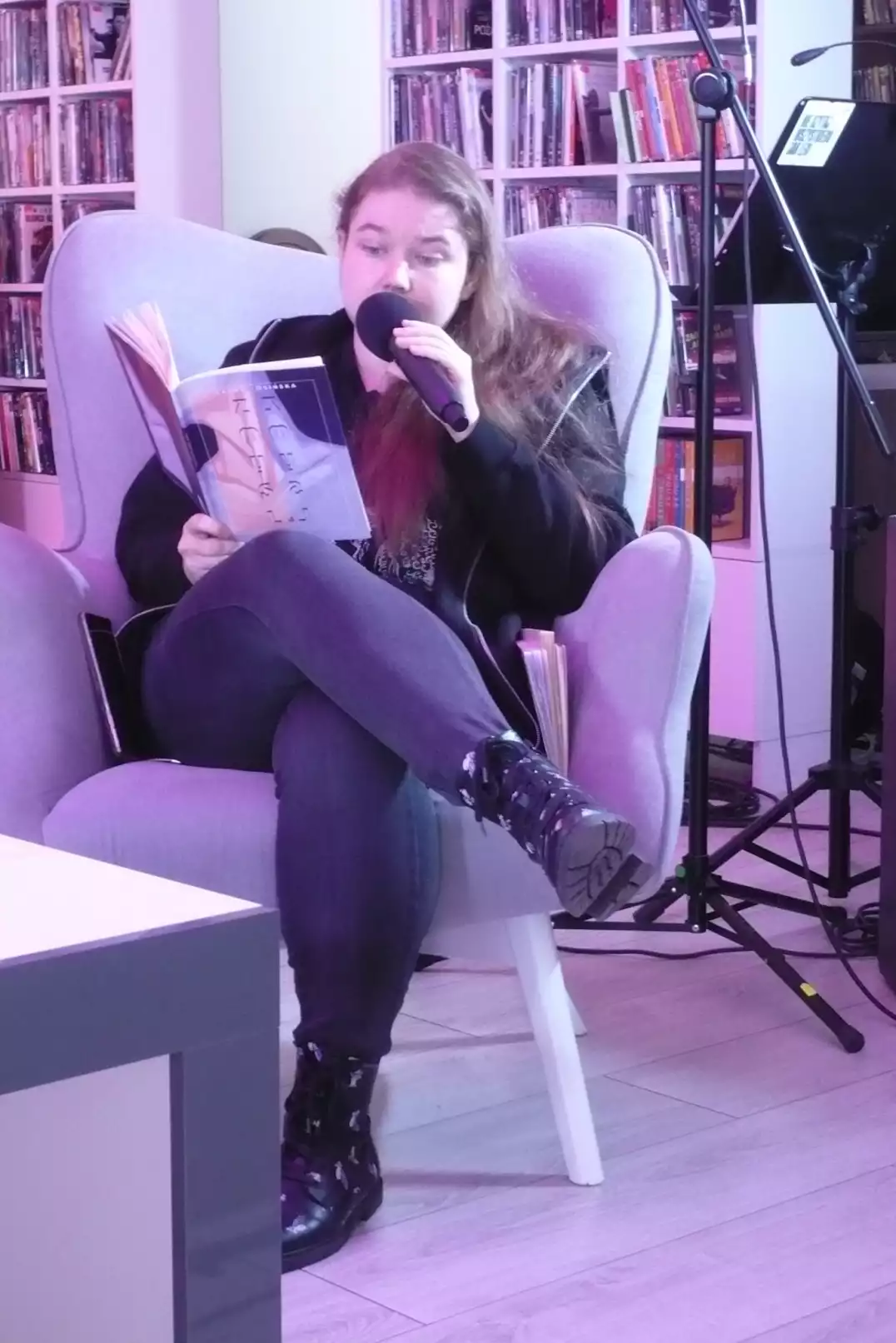Anna Adamowicz czyta swoją twórczość siedząc w fotelu - powiększenie