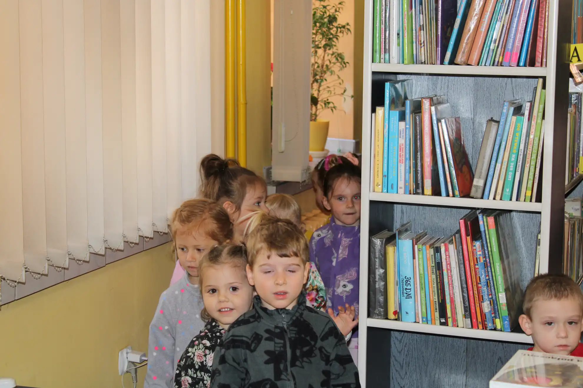 Dzieci spacerują między regałami.  - powiększenie