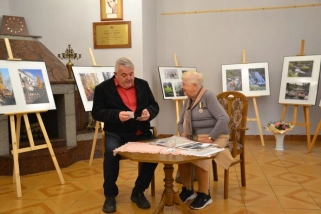 Przewodniczący Rady Miejskiej Andrzej Bechan i Irena Dąbek siedzą przy stoliku w Sali Kominkowej MBP